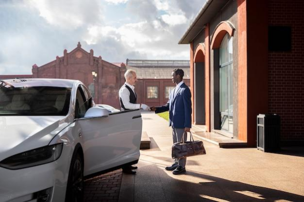 A chauffeur greeting a corporate professional