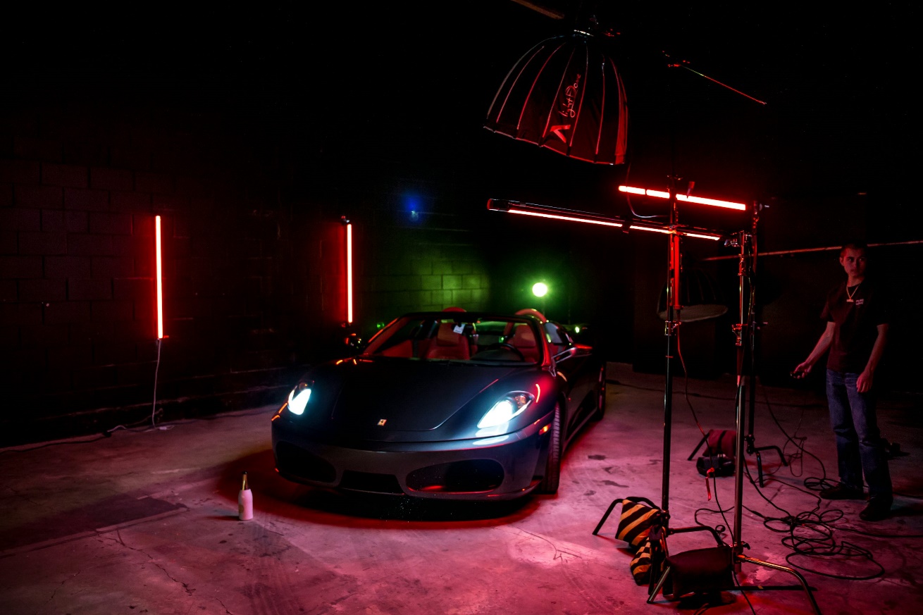 An exotic car under lights in a studio